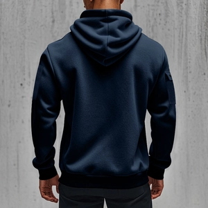 Detail view of navy blue cotton hoodie featuring a functional cargo pocket on the sleeve