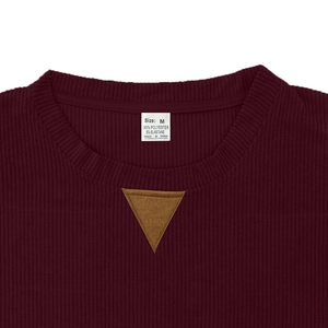 Detail view of burgundy corduroy sweatshirt neckline with size label and ribbed texture