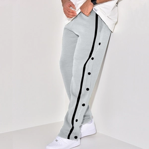 Detail of light gray casual joggers featuring side black stripes and button accents