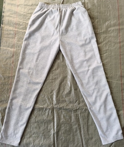 Detail of light gray waffle knit joggers with elastic waistband and drawstring