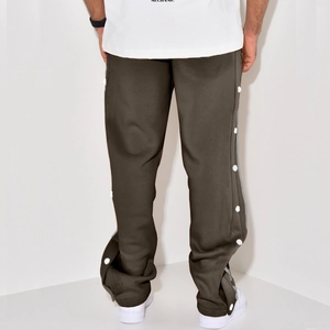 Detail view of men's vintage brown straight-leg trousers with side white snap buttons