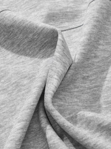 Close-up of heather grey knit fabric texture with detailed stitching and soft drape