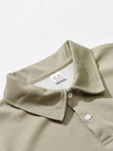 Macro detail of men's sage green polo shirt collar with honeycomb knit texture