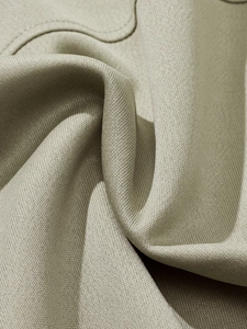 Macro view of olive green polo shirt fabric showing soft texture and premium drape
