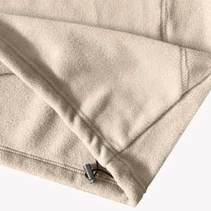 Detail of polar fleece hoodie hem with metal cord lock and adjustable drawstring