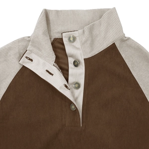 Close-up of brown corduroy sweatshirt with raglan sleeves and vintage metal buttons