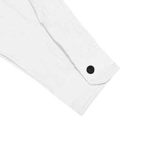 Close-up of white cotton linen shirt sleeve showing fine texture and black button detail