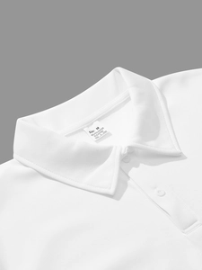 Detail view of the white polo shirt collar and size tag showing material composition