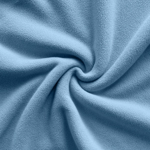 Detailed macro view of soft light blue polar fleece fabric texture and warm fiber material