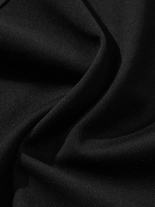 Macro shot of high-quality heavy black knit fabric with premium matte texture and soft drape