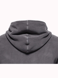Detailed close-up showing the soft polar fleece texture on a dark grey hooded sweatshirt