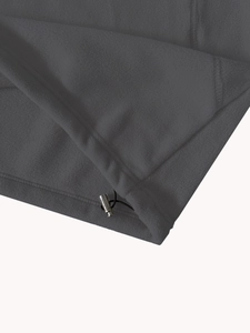 Detail of dark grey fleece hoodie hem with elastic drawstring and metal toggle adjuster