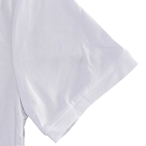 Close-up of white polo shirt sleeve showing breathable pique knit fabric texture