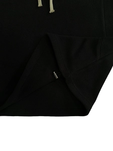 Detail of black fleece hoodie showing warm texture, drawstring and adjustable hem buckle