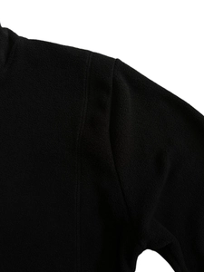 Detail shot of the shoulder stitching and soft black fleece texture on this thermal hoodie