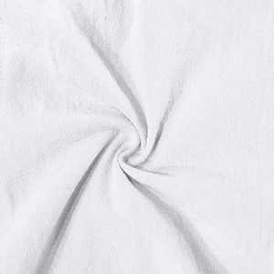 Close-up of white breathable linen fabric showing soft texture and natural fibers