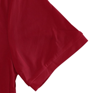 Detailed macro view of dark red polo shirt cuff with breathable piqué mesh fabric texture