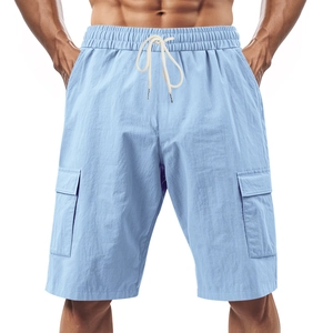 Close-up of light blue linen cargo shorts with elastic drawstring waist and side flap pockets