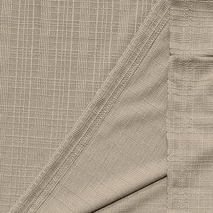 Detailed close-up of beige linen-like fabric with fine grid texture and reinforced stitching