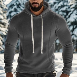 Men's dark gray polar fleece hoodie with contrast drawstrings in a winter snow setting