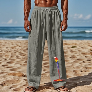 Détail du pantalon en lin gris avec imprimé perroquet coloré sur fond de plage