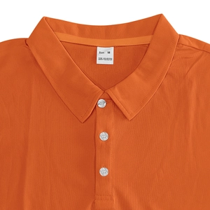 Detail of orange polo shirt collar showing three-button placket and 100% polyester label