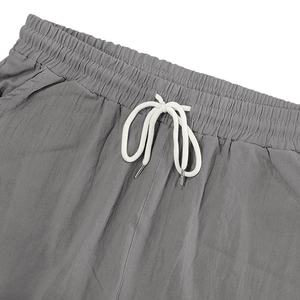 Détail de la taille élastique avec cordon blanc sur ce pantalon en lin gris chiné