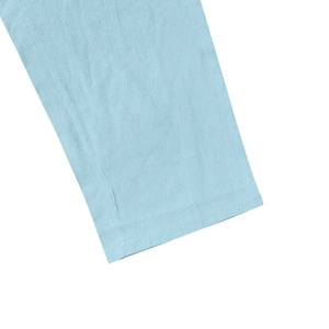 Macro detail of light blue cotton linen fabric showing precise stitching and woven texture