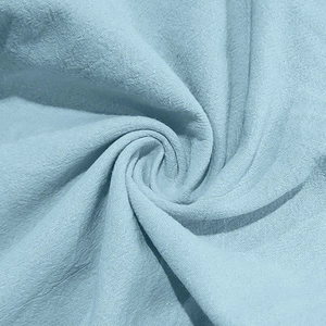 Detailed macro view showing the soft texture and weave of light blue cotton linen fabric