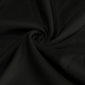 Macro shot of black honeycomb mesh fabric with breathable micro-pore texture for polo shirts