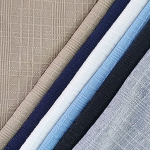 Close-up of textured waffle knit fabric in various colors for casual men's Henley shirts