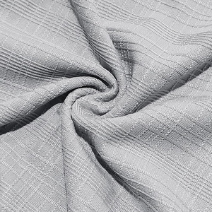 Macro detail of breathable light grey knit fabric with vertical ribbing and fine textures