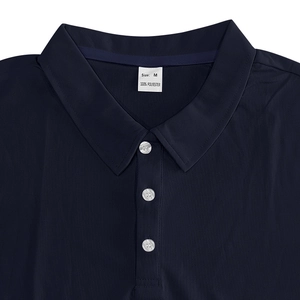 Detail of the navy blue polo shirt showing the collar, buttons, and breathable mesh fabric