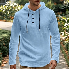 Men's light blue cotton linen hooded shirt with buttoned collar in an outdoor setting