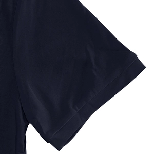 Close-up detail of dark blue polo shirt sleeve featuring breathable mesh fabric texture
