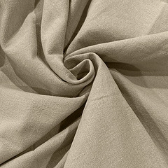 Close-up of beige cotton linen fabric showing natural texture and soft drape detail