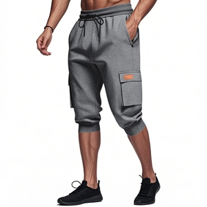 Detail of grey cargo shorts featuring heavy cotton fabric, side pockets and elastic drawstring