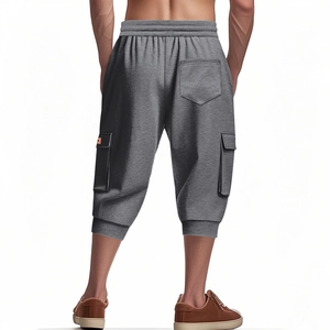 Rear view of men's grey cargo shorts showing multi-pockets and ribbed cuffs on white back