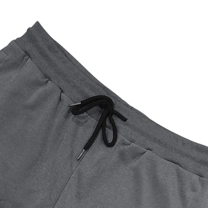 Detail of grey cargo shorts featuring an elastic ribbed waistband and black drawstrings