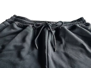 Detail of men's cargo shorts with elastic drawstring waist and metal-tipped cords
