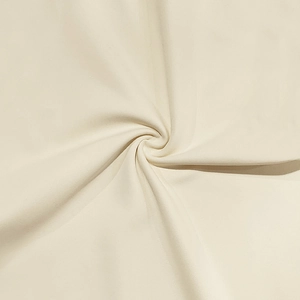 Detailed macro view showing the soft texture and weave of the cream-colored jersey fabric