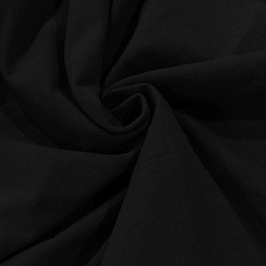 Close-up of black cotton linen fabric showing fine weave texture and soft drape detail