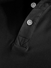 Detail of black polo shirt placket featuring classic buttons and piqué fabric texture