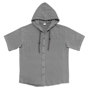 Detailed close-up of textured grey cotton linen fabric and buttons on hooded short sleeve shirt