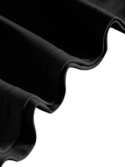 Detail of black polo shirt showing the ruffled edge and reinforced double stitching