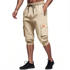 Detail of khaki cargo shorts with elastic waist, contrast drawstrings and side flap pockets
