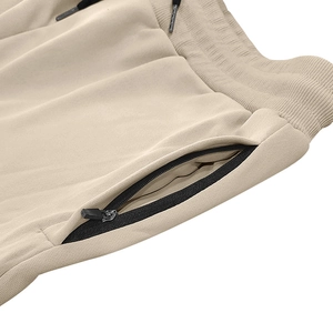 Detail of khaki cargo shorts with ribbed elastic waistband, drawstrings and zip pockets