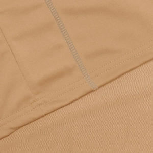 Macro detail of khaki tracksuit fabric showing high-quality double-needle reinforced stitching