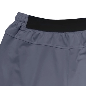 Macro shot of dark grey sports shorts showing the elastic black waistband and neat stitching