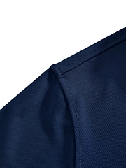 Close-up of navy blue polo shirt shoulder with breathable honeycomb mesh fabric texture